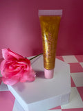 24K Diva Gold Lip Gloss squeeze tube with pink rose on pink checkered background