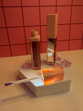 Diva's Love Cosmetics luxury lip gloss in rich brown shade, open with applicator displayed