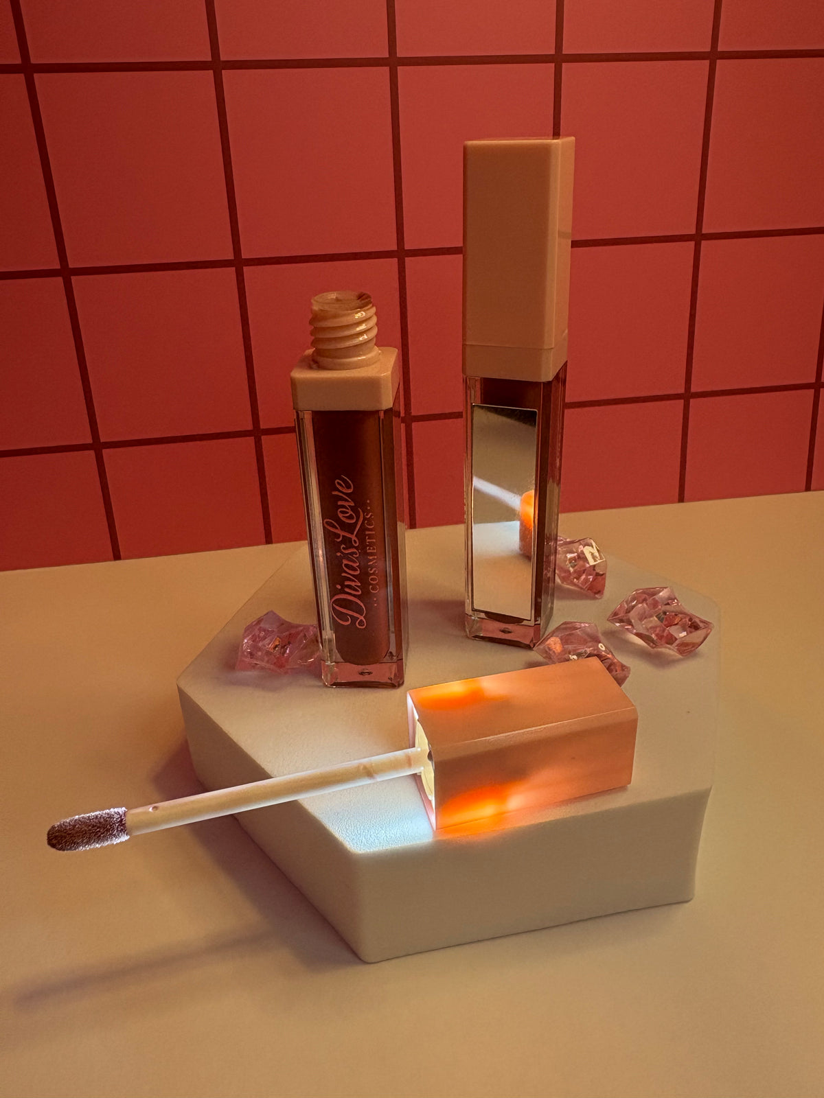 Diva's Love Cosmetics luxury lip gloss in rich brown shade, open with applicator displayed