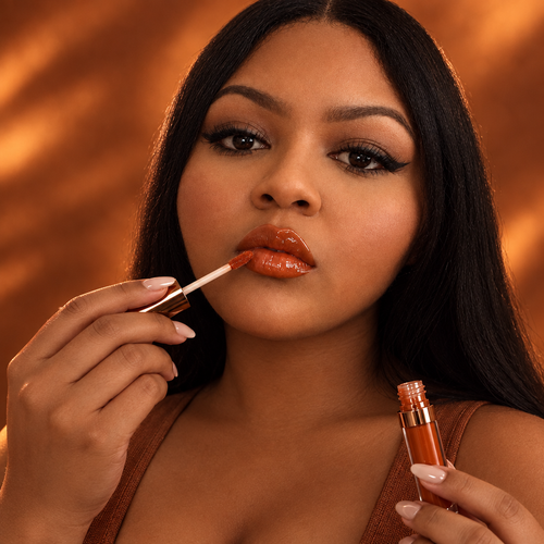 AI-edited Brunt Orange portrait holding lip gloss
