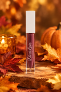 Diva's Plum lip gloss with autumn leaves and pumpkin