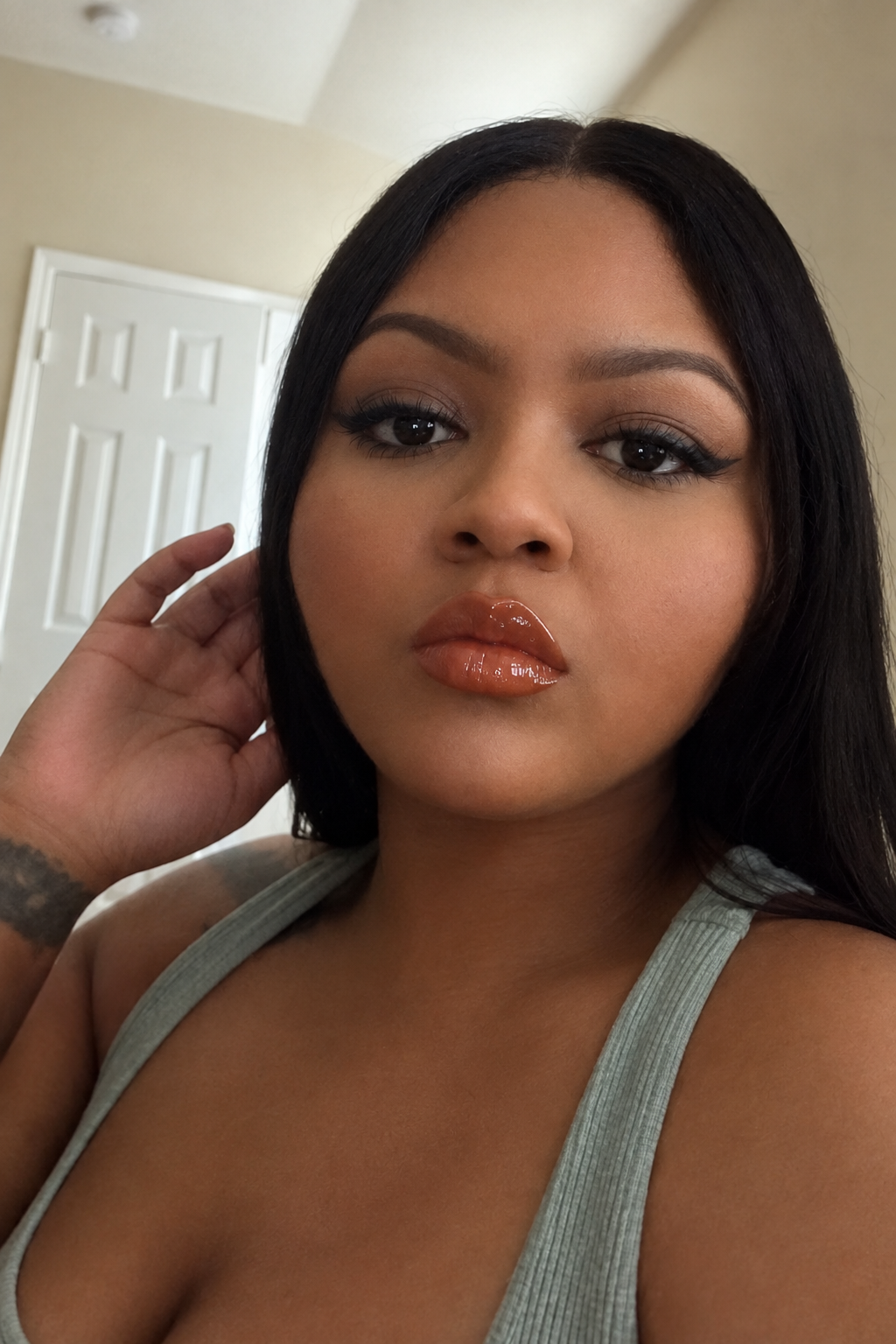 Beauty portrait showing a glossy burnt-orange lip look